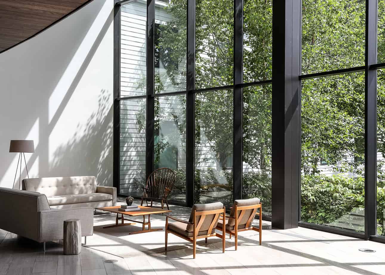 Light-filled reception area with floor-to-ceiling windows at Mountainside addiction treatment center.