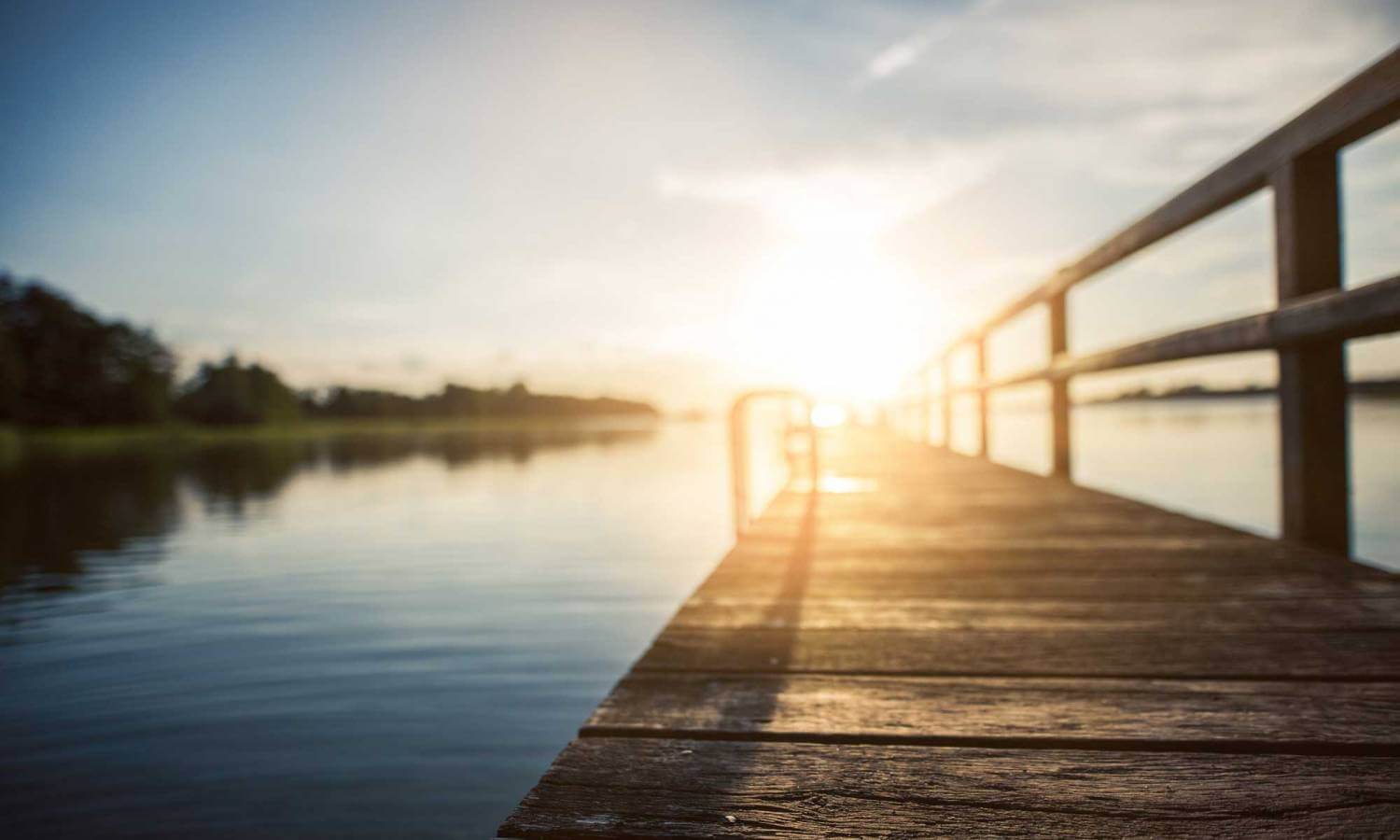 Blurry sunset near a dock or boardwalk.